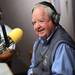 Former Michigan assistant coach Jerry Hanlon smiles as he speaks on the air at WTKA 1050 during a fundraiser for Mott Children's Hospital at the station on Friday. Melanie Maxwell I AnnArbor.com